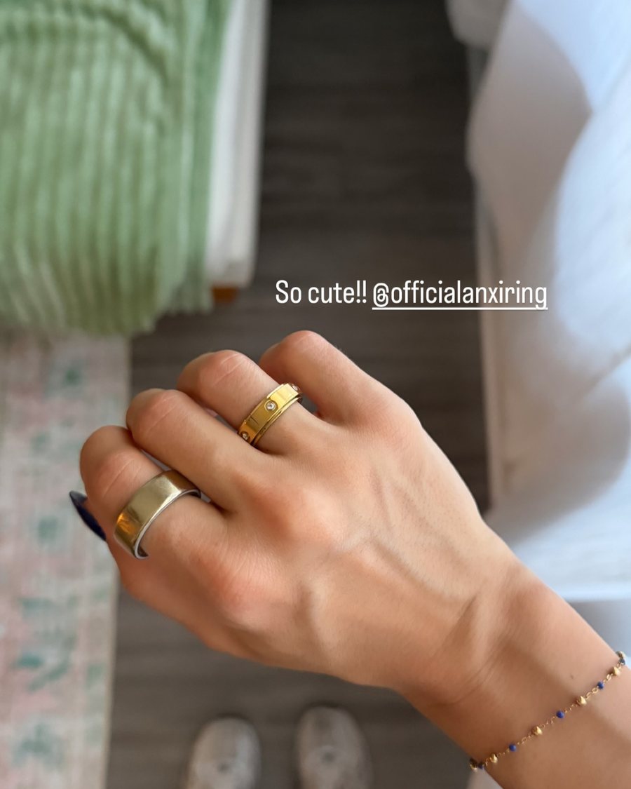 Hand with gold Anxi Rings, so cute, tagged @officialanxiring