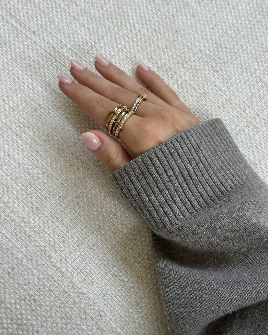 Gold Anxi Rings worn with a cozy knit sweater
