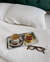 Disturb Me Not eye patches in their gold tin on a breakfast tray with a Day & Night ring