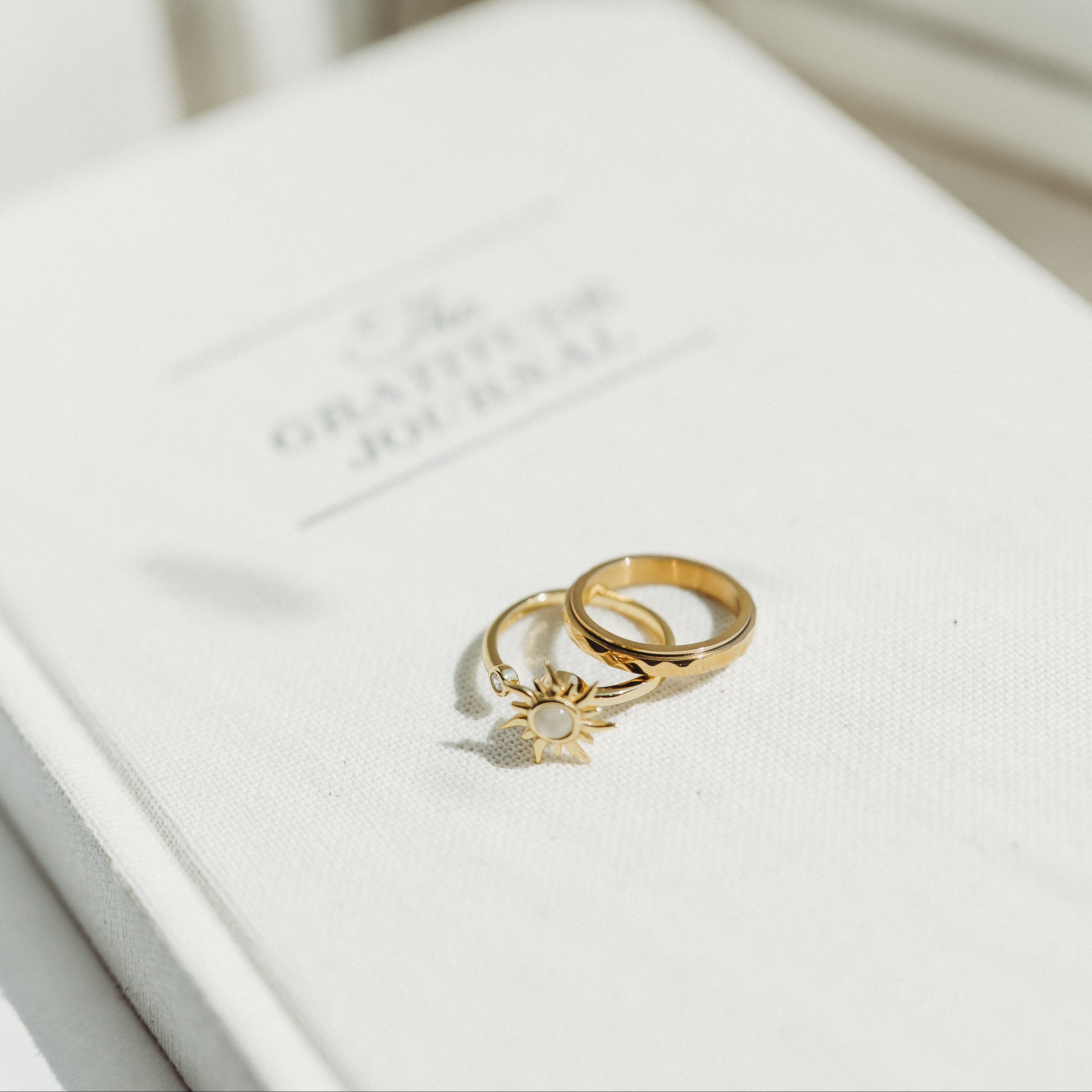 Gold ring with a star design on a white surface