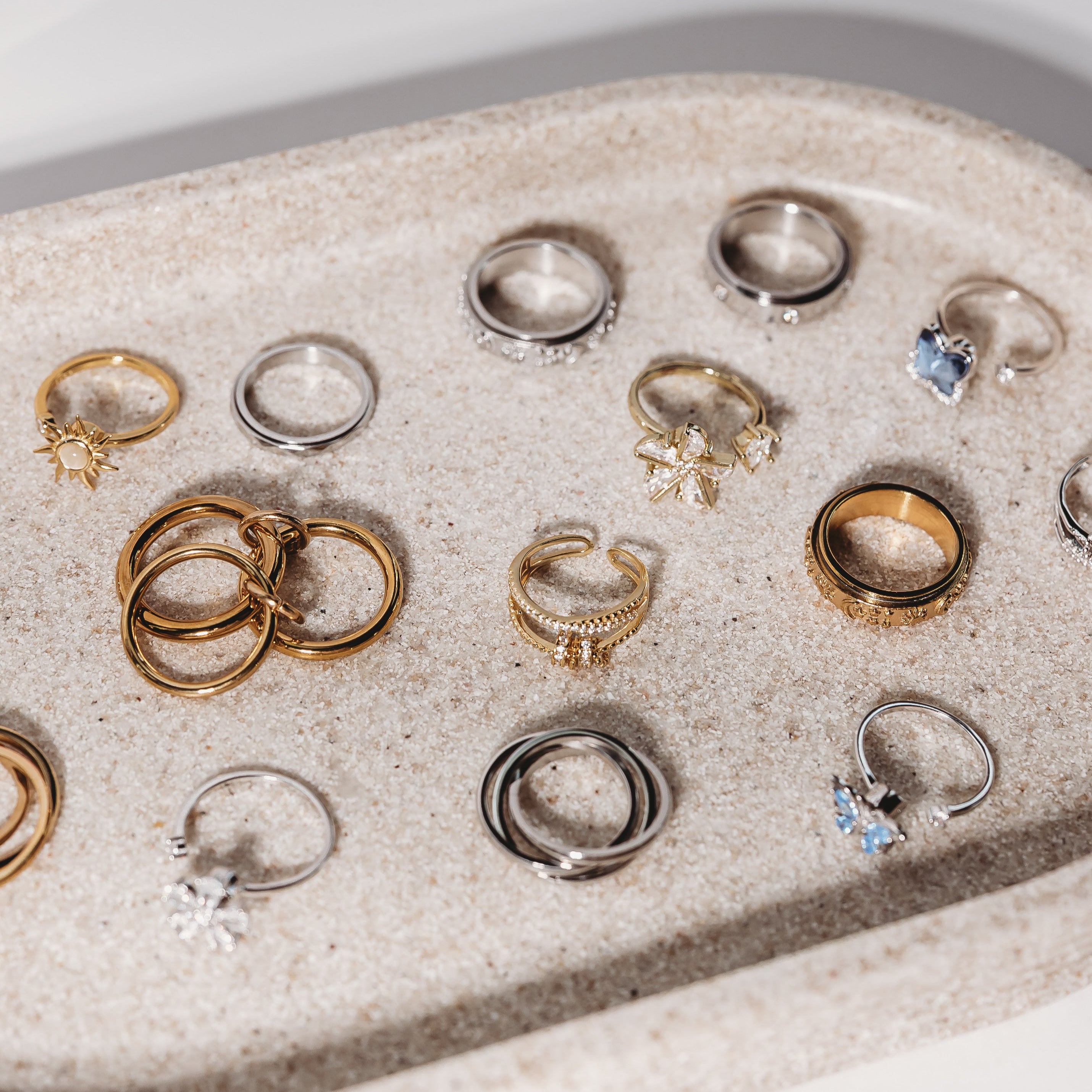 Collection of various rings on a textured surface