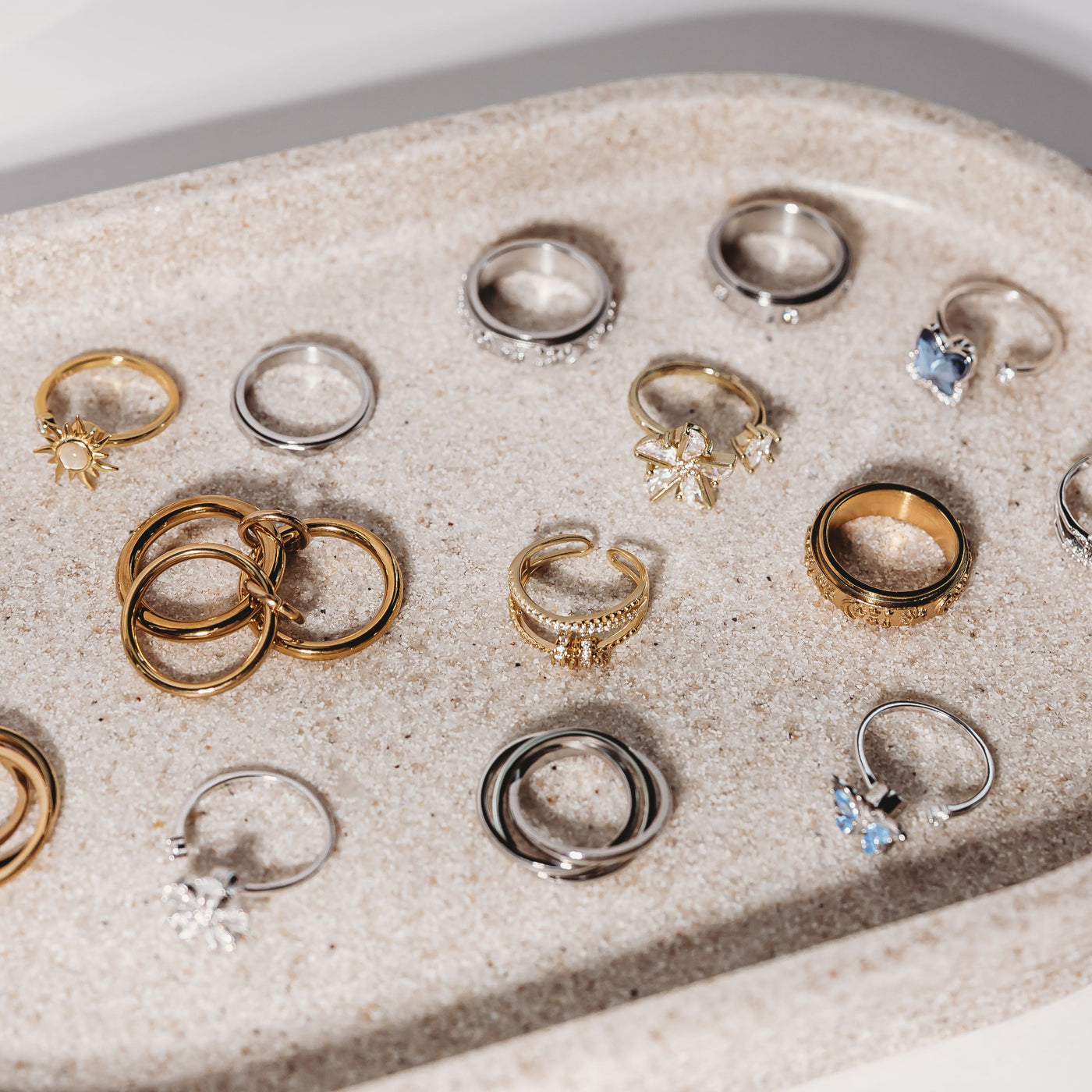 Collection of various rings on a textured surface