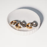 Set of gold and silver rings on a white surface