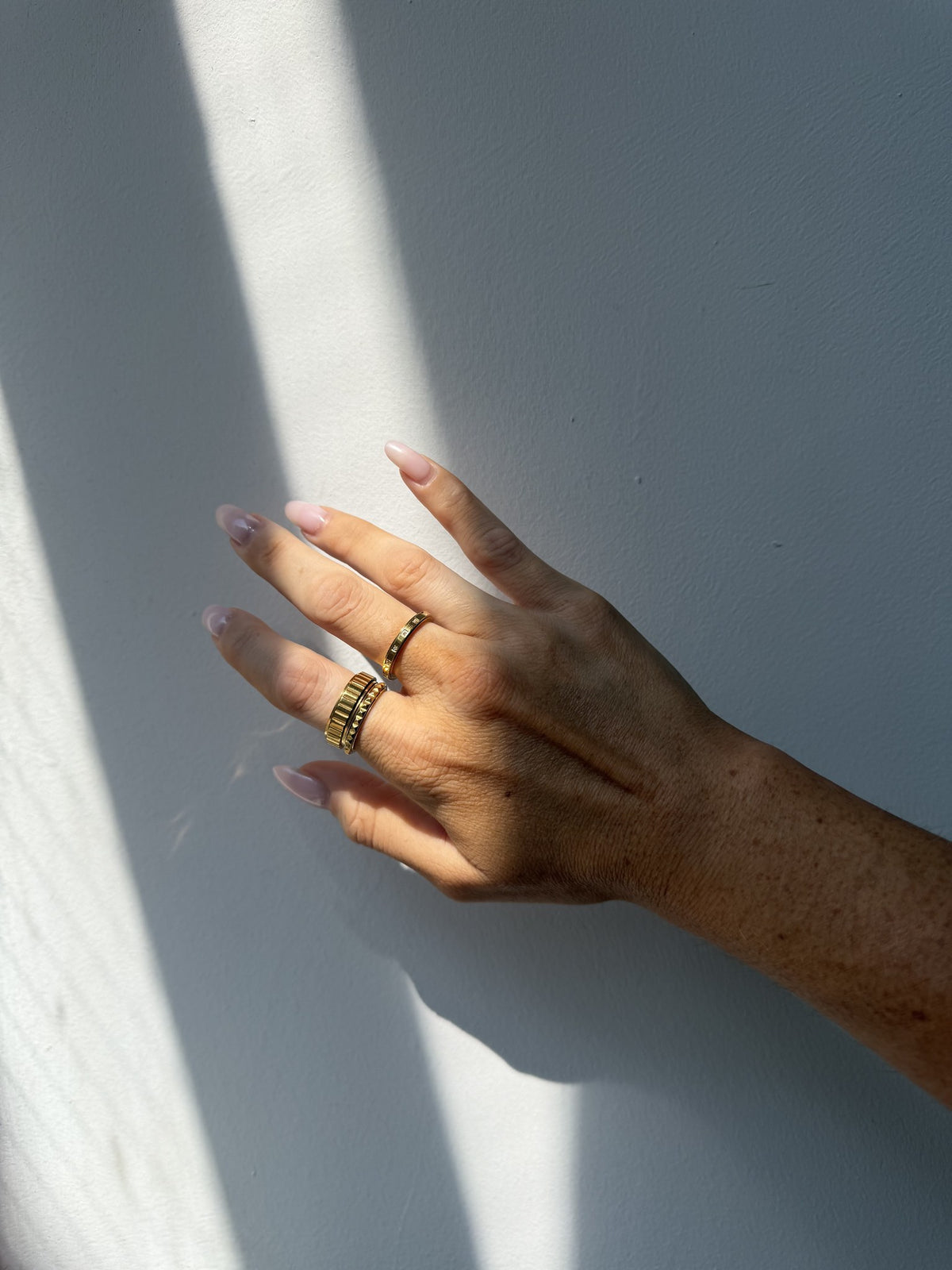 Close-up of the Above It All Rotator Anxi Ring in gold, showing the studded band on the hand
