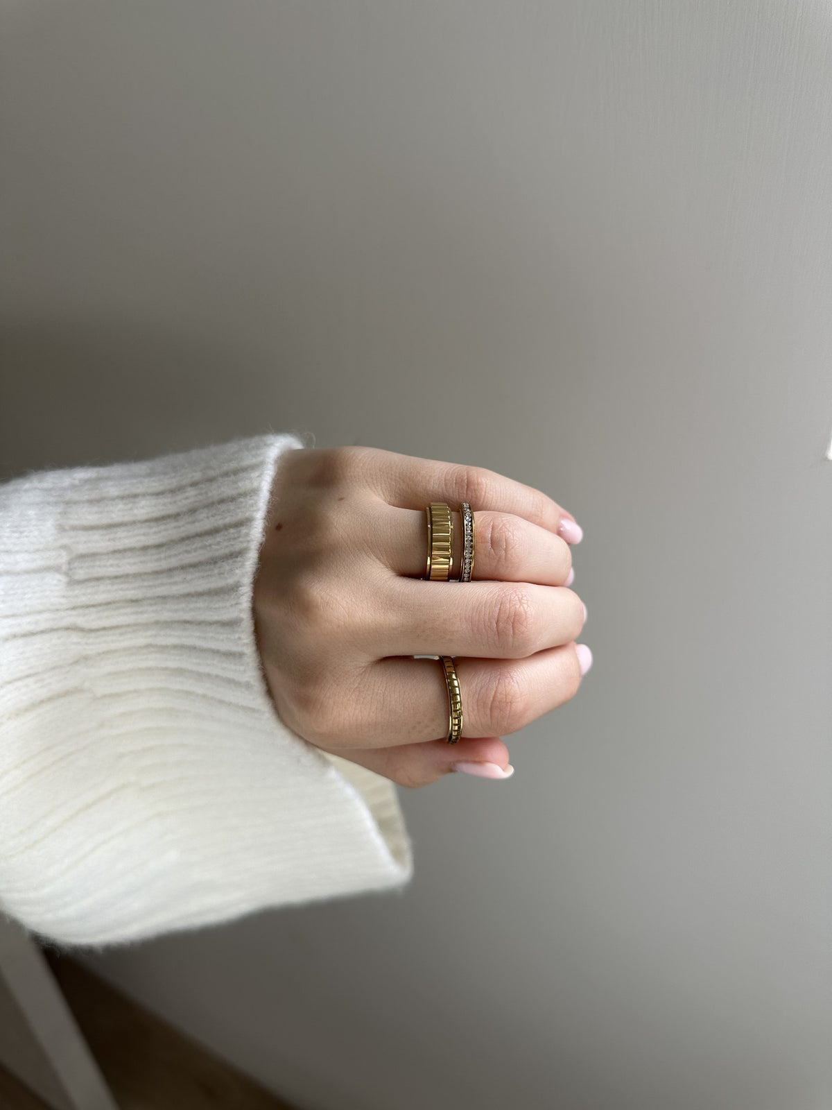 Close-up of the My Way Rotator Anxi Ring in gold, showing the ridged band on the finger