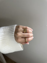 Close-up of the My Way Rotator Anxi Ring in gold, showing the ridged band on the finger