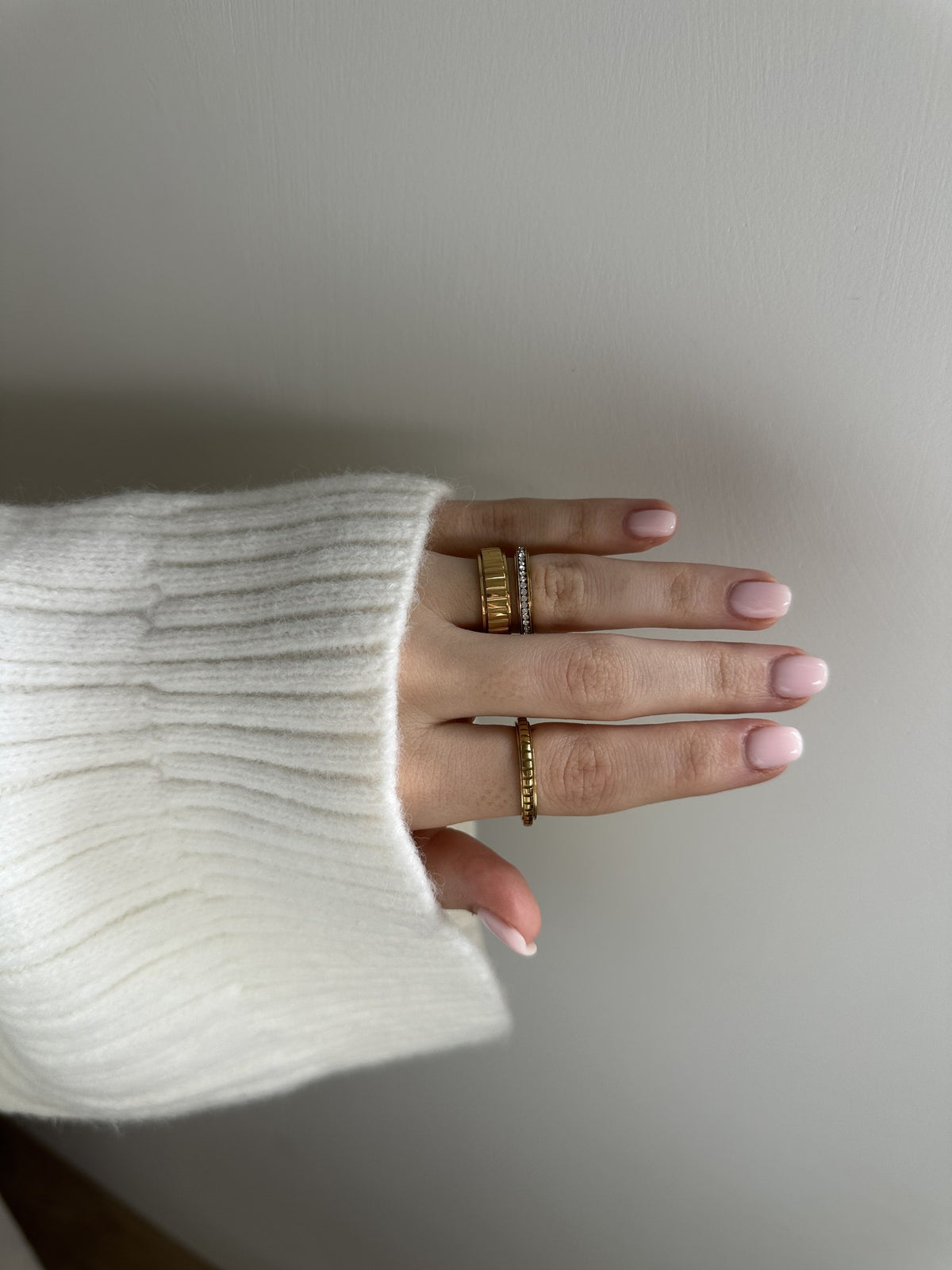 Close-up of the No Big Deal Rotator Anxi Ring in gold, showing the wide fluted band