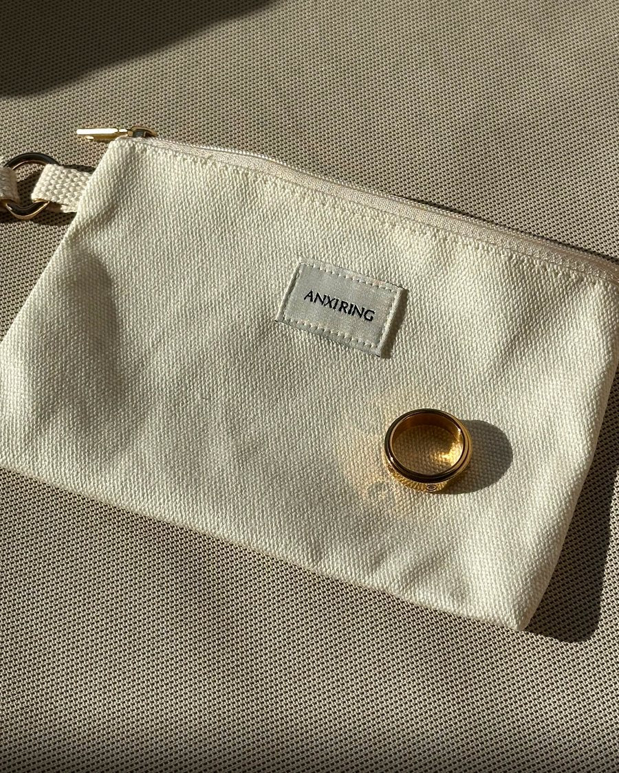 Gold Anxi Ring on the canvas pouch in the sun