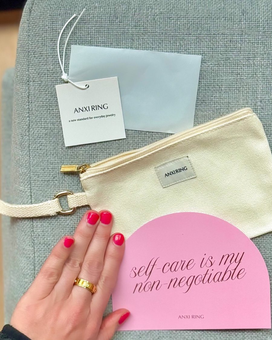 Anxi Ring unboxing with the pink self-care card and a gold ring
