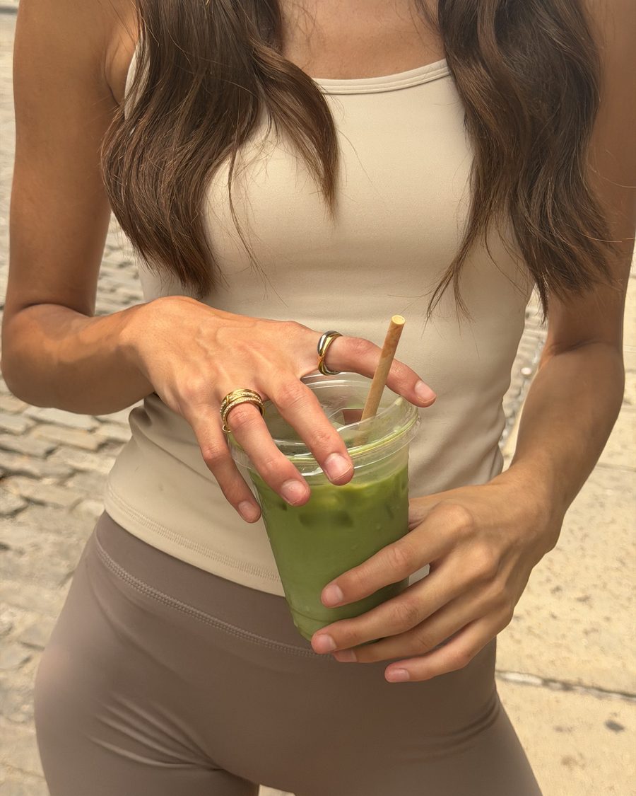 Customer holding an iced matcha, Anxi Rings on both hands