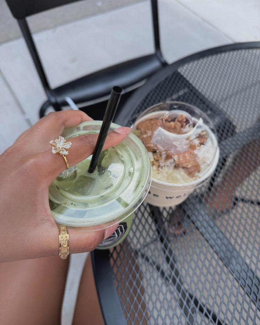 Flower Anxi Ring holding an iced matcha at a cafe table